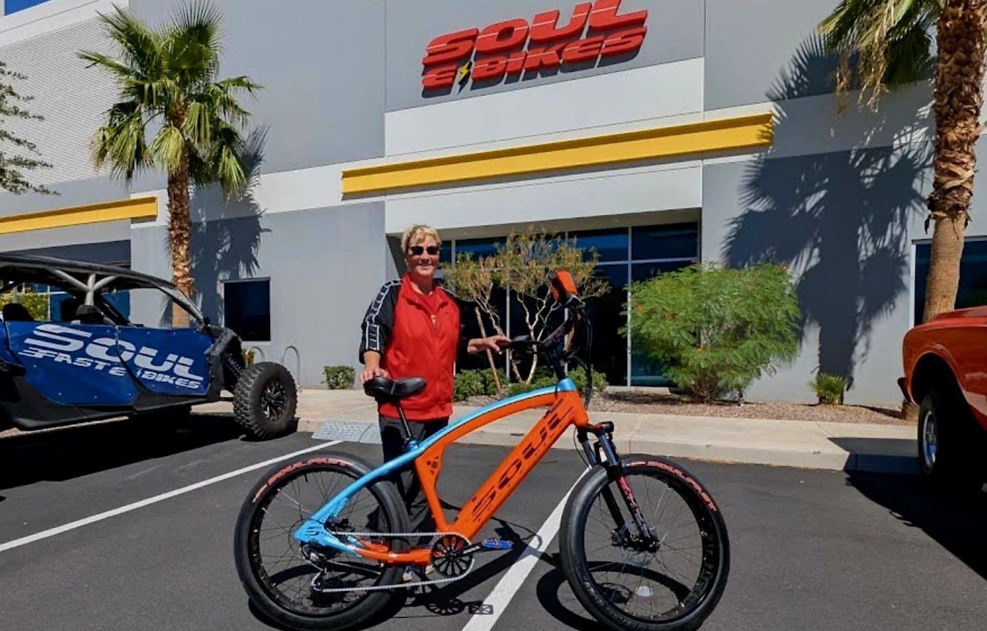 Person with colorful bike outside Soul Bikes.