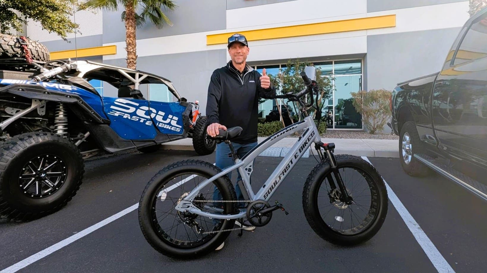Man giving thumbs up with electric bike.