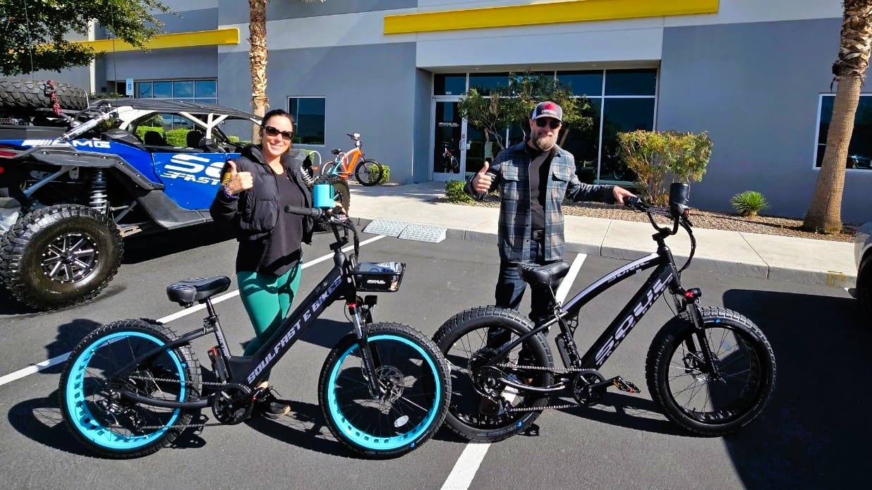 People with electric bikes giving thumbs up.