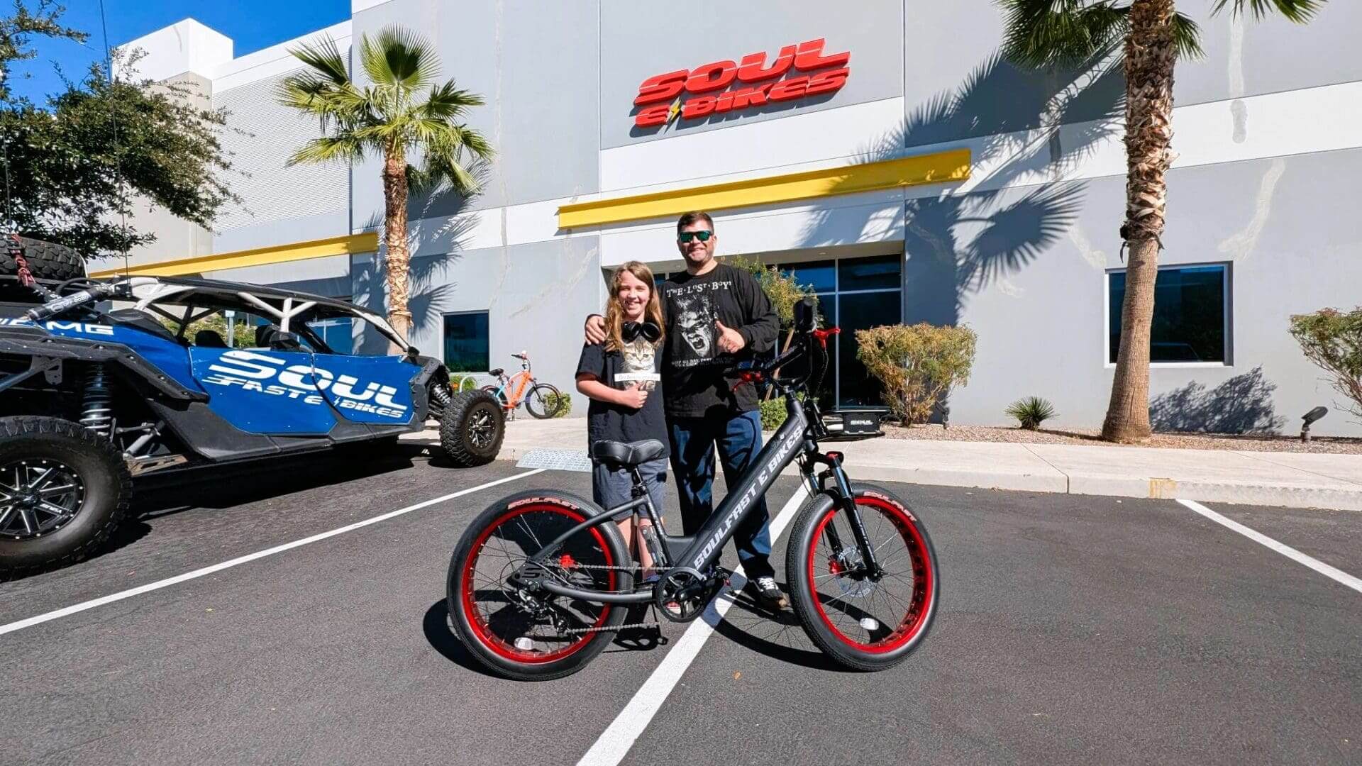 People posing with bicycle outside Soul premises.